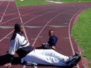 Mr. Alphanso Linley and son relax during a practice session.