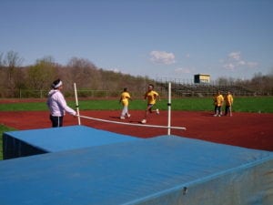 Club President and Coach's Assistant Rosa St. Lawrence, puts the high jumpers through their paces.