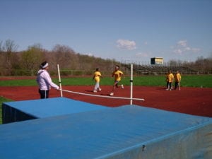 Club President and Coach's Assistant Rosa St. Lawrence, puts the high jumpers through their paces.